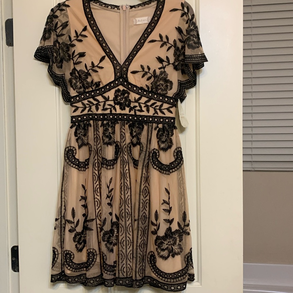 Beautiful, NEW dress with black trim over lined skirting. Beige and black.